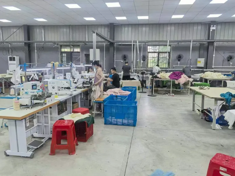 Production floor with sewing machines and stock crates